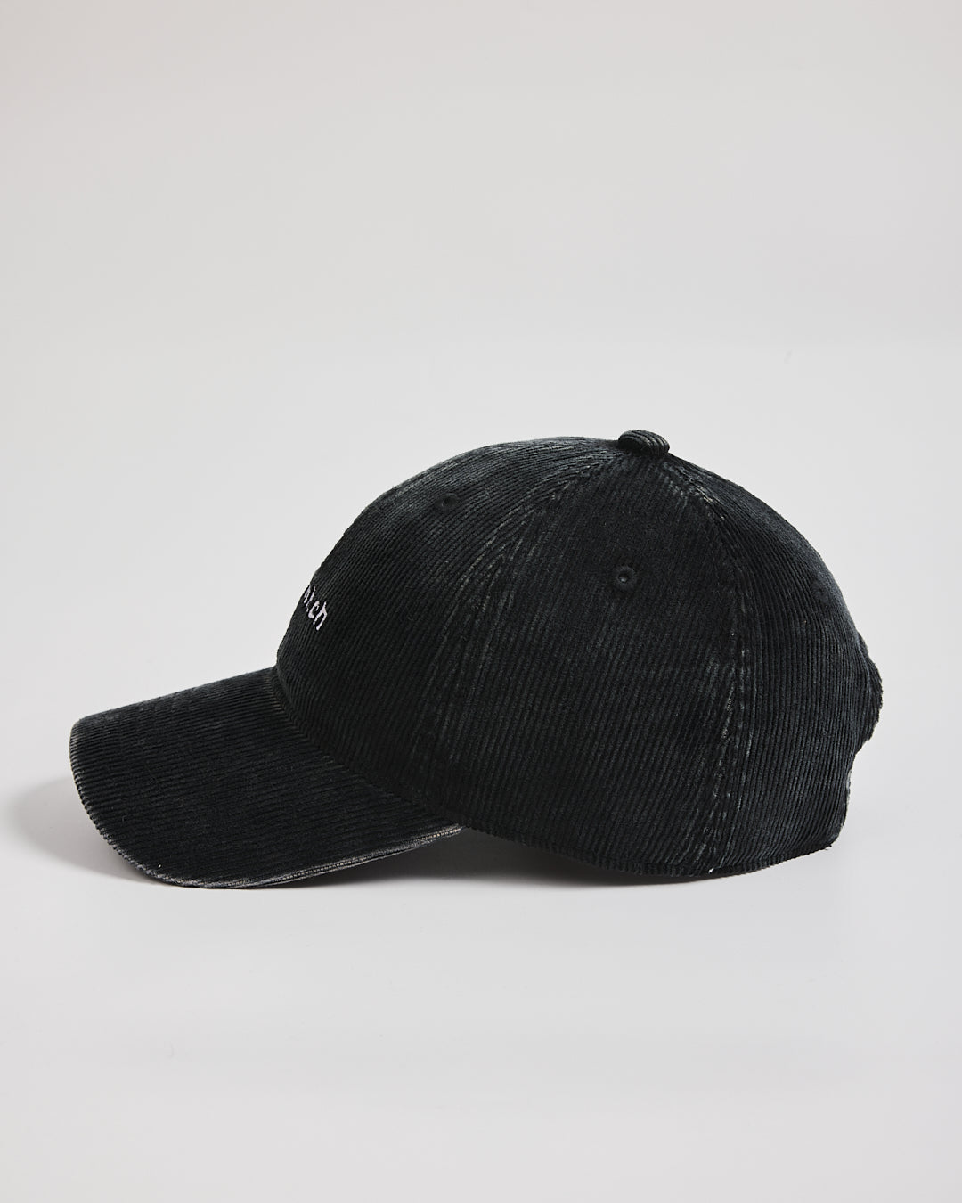 Black baseball cap on a light gray background