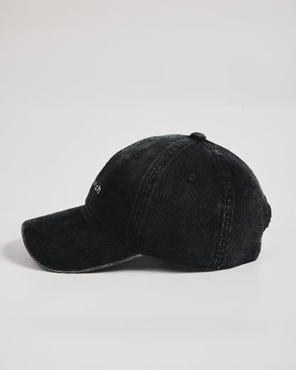 Black baseball cap on a light gray background