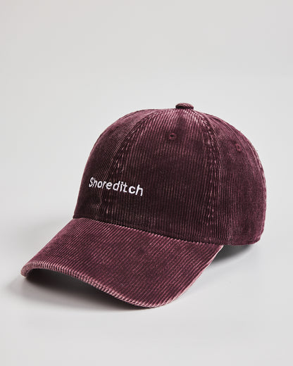 Maroon cap with 'Shoreditch' text on a light gray background