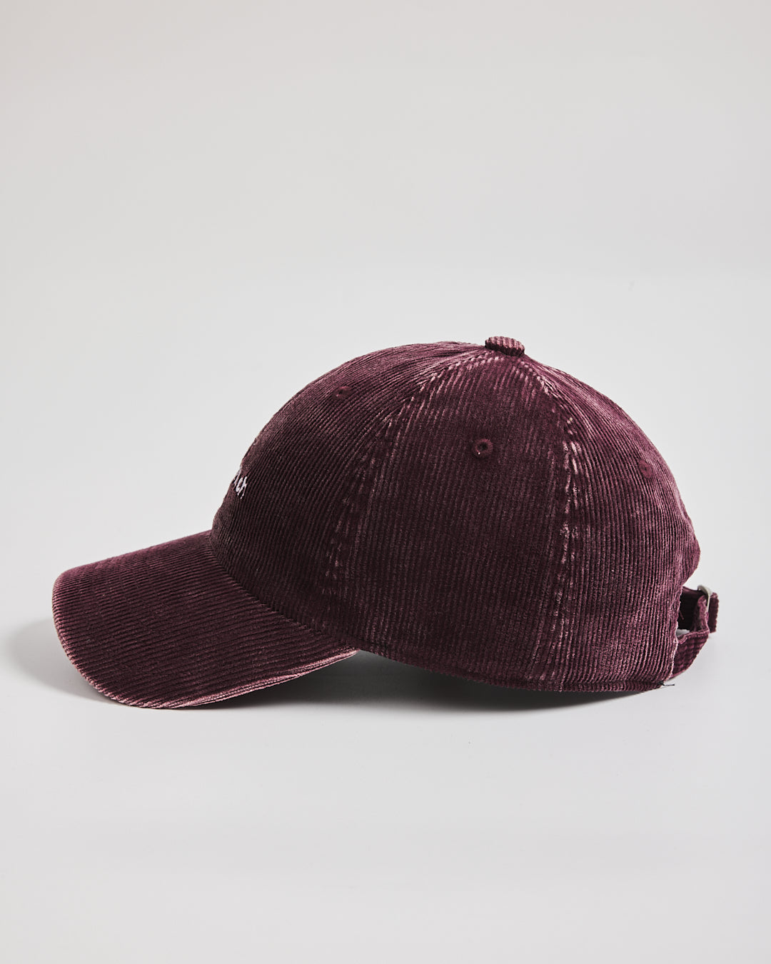 Maroon baseball cap on a light gray background