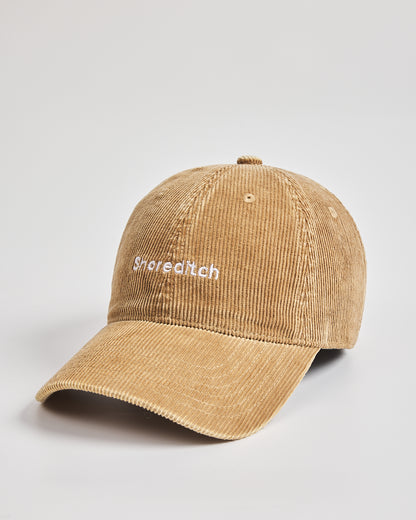 Camel cap with 'Snoreeditch' text on a light gray background
