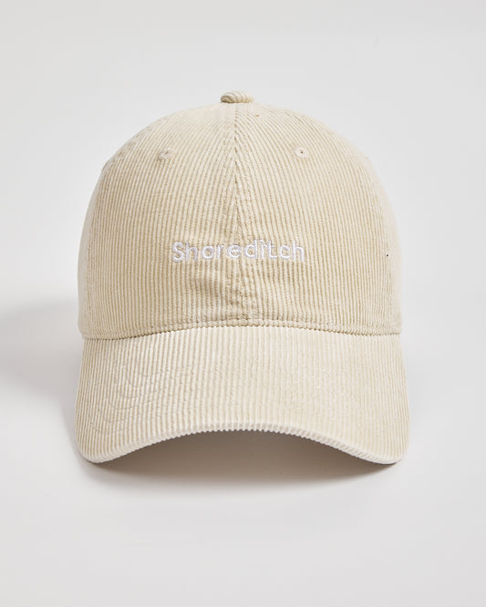 Cream corduroy cap on a light gray background