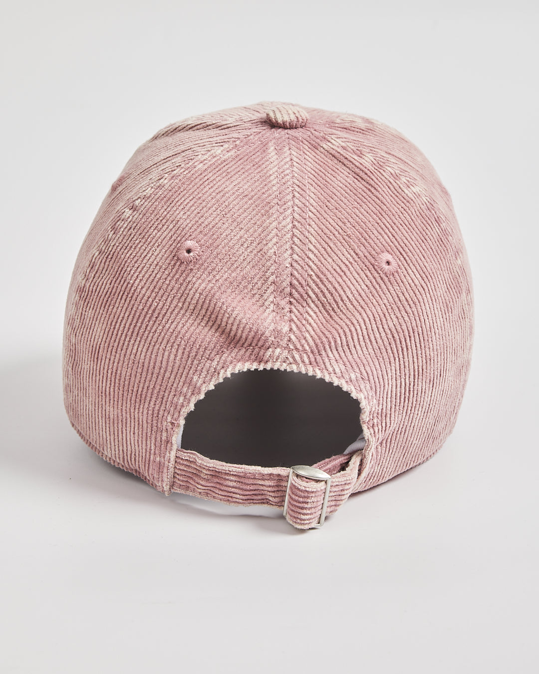 Pink corduroy cap on a light gray background
