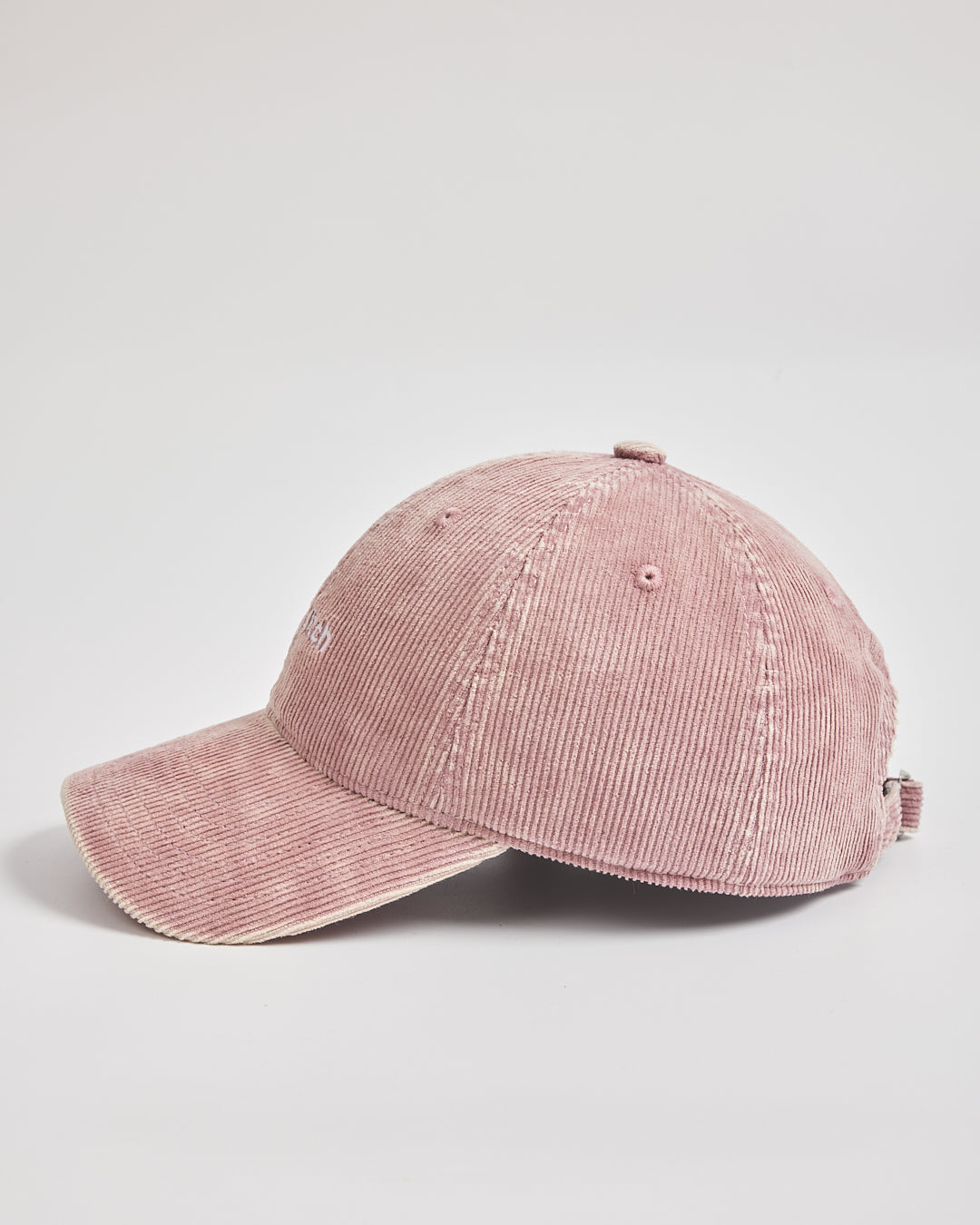 Pink corduroy cap on a light gray background