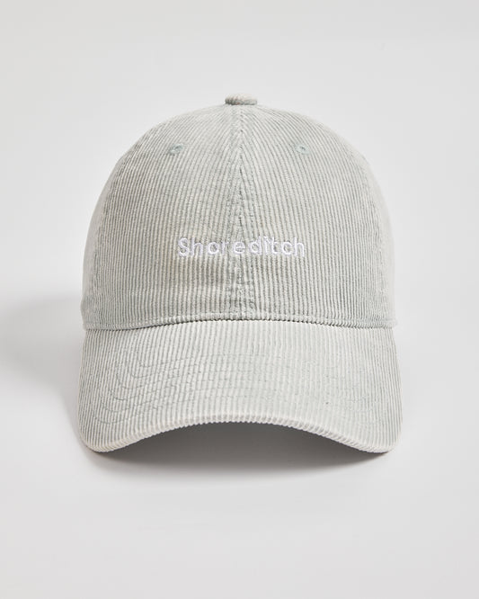 Light gray corduroy cap on a white background with 'Shoe & Stitch' branding.