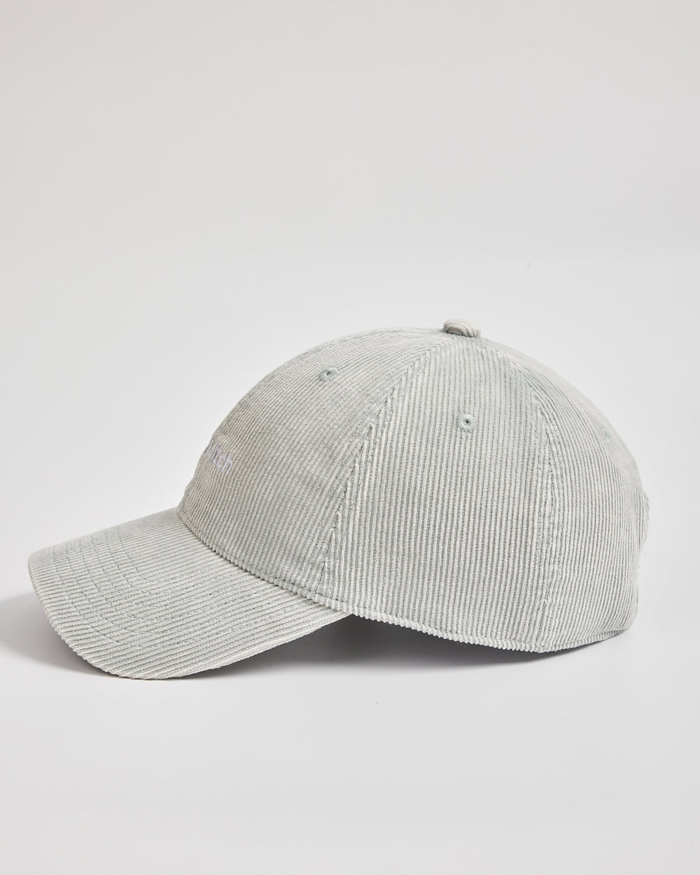 Gray corduroy baseball cap on a light gray background