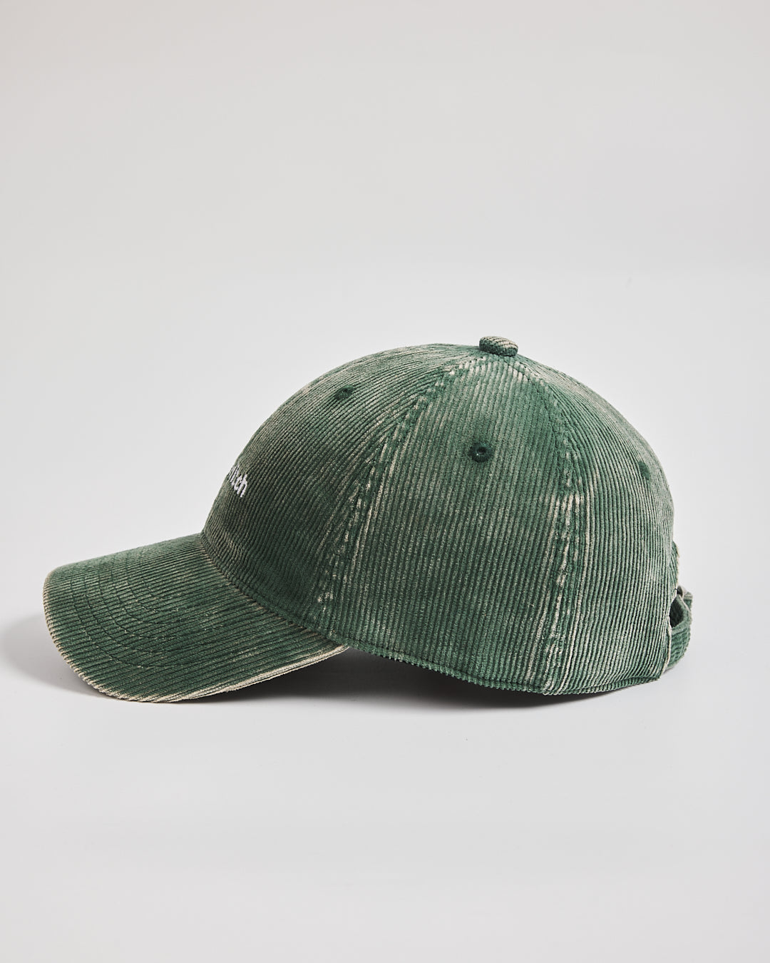 Green corduroy cap on a light gray background