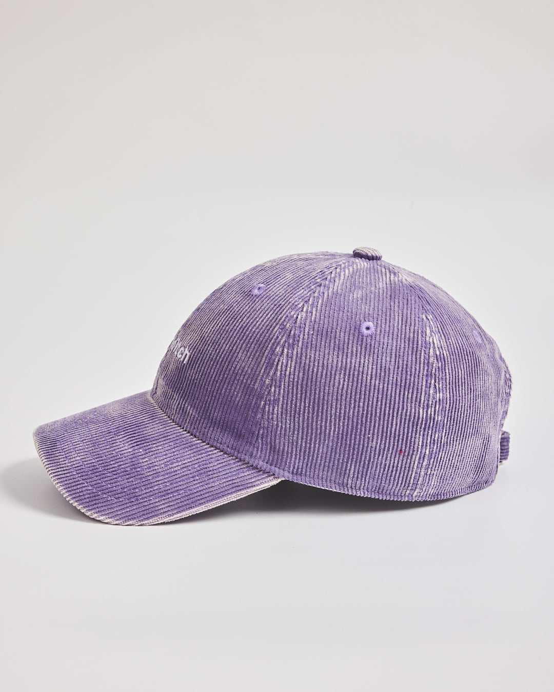Purple corduroy cap on a light gray background