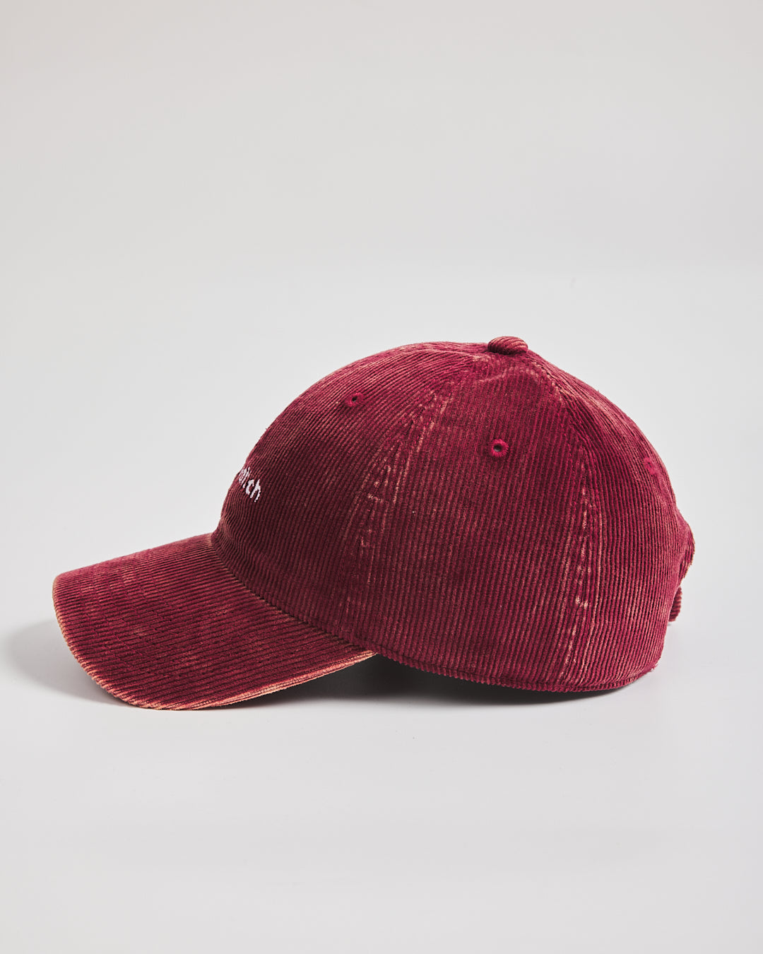 Red corduroy cap on a light gray background