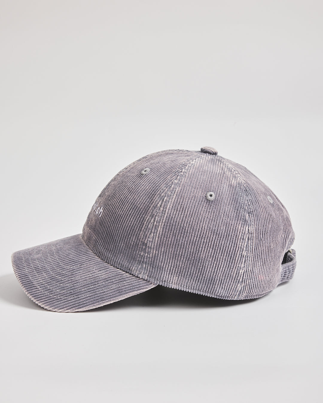 Gray corduroy baseball cap on a light gray background