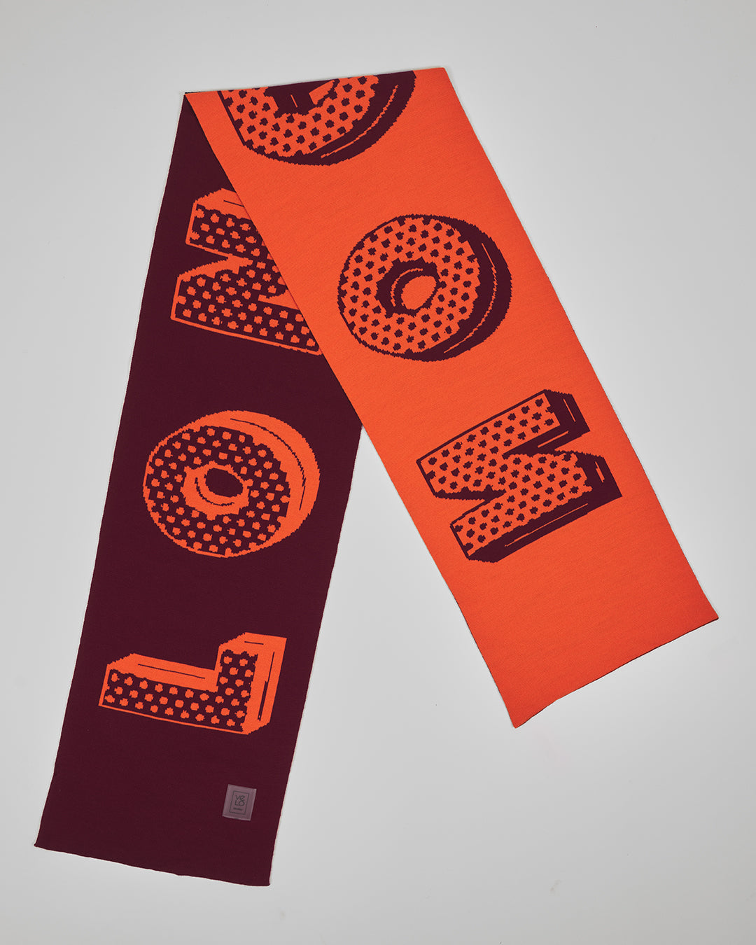 Soho Wine unisex acrylic scarf flat lay in deep wine burgundy and vivid coral orange
