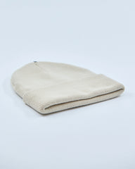 stone white beanie hat on a light gray background