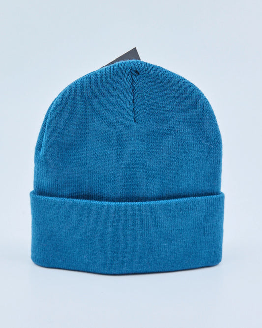 Teal blue beanie on a light blue background