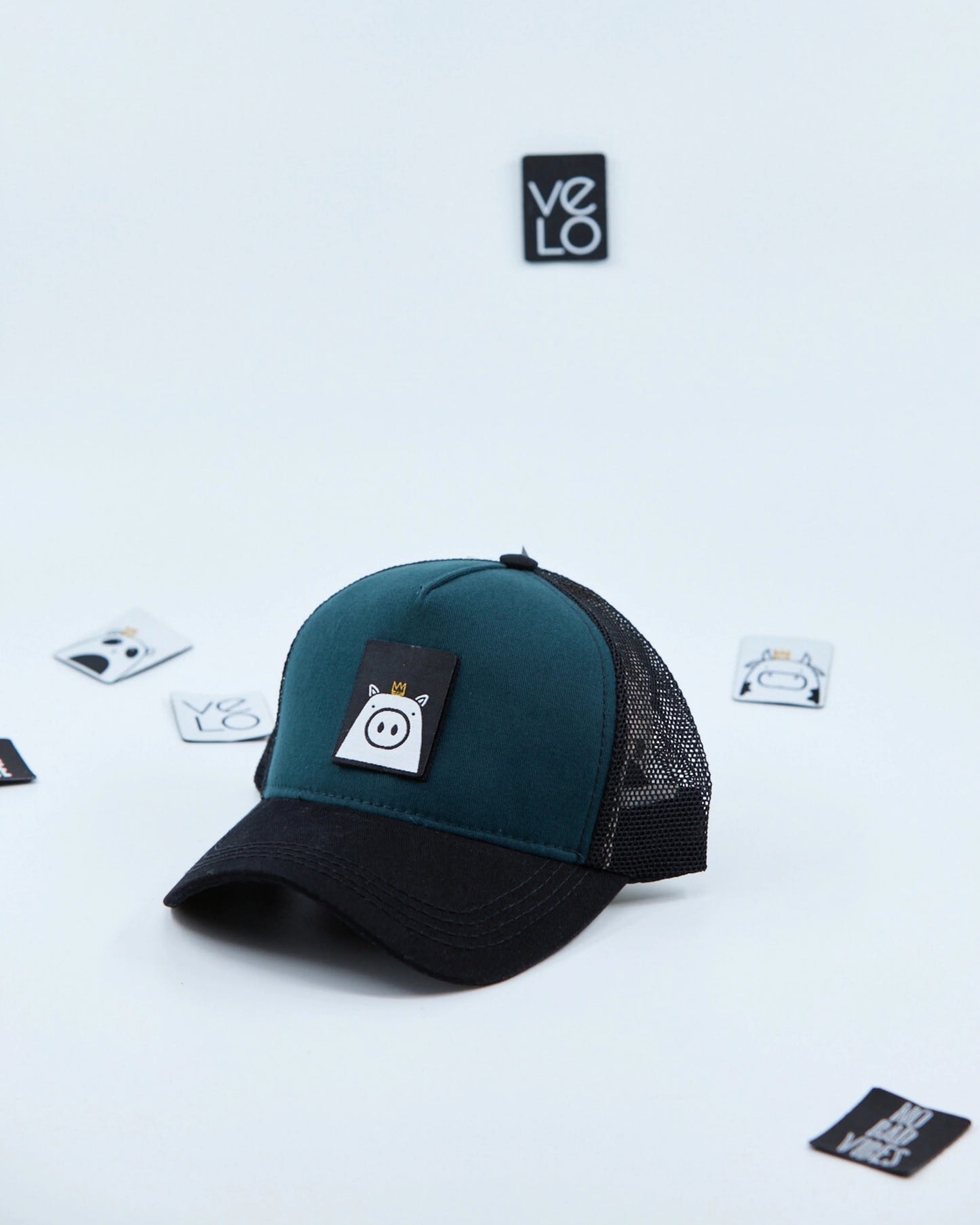 Side view of Teal Green and Black Customisable Trucker Cap with patches