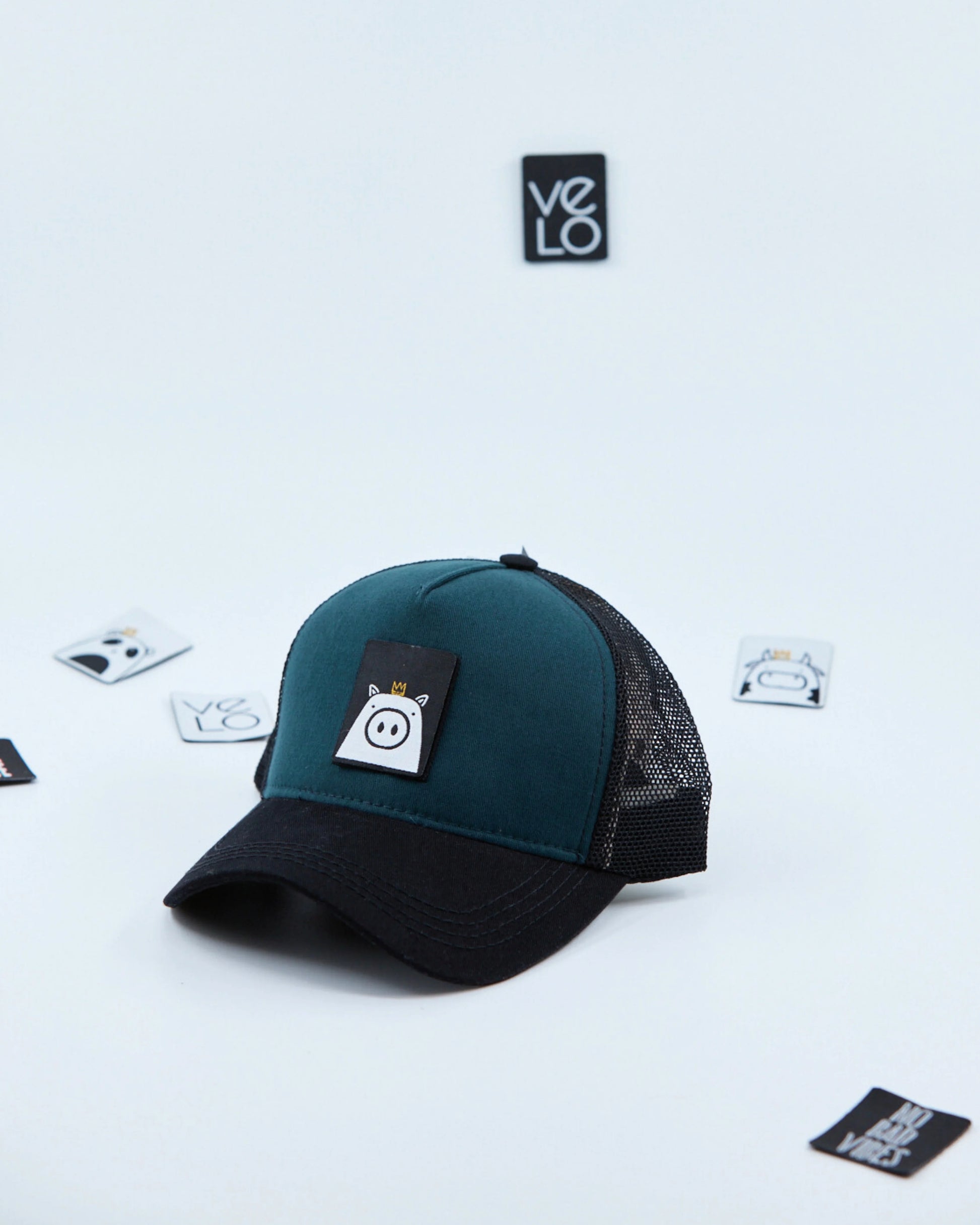 Side view of Teal Green and Black Customisable Trucker Cap with patches