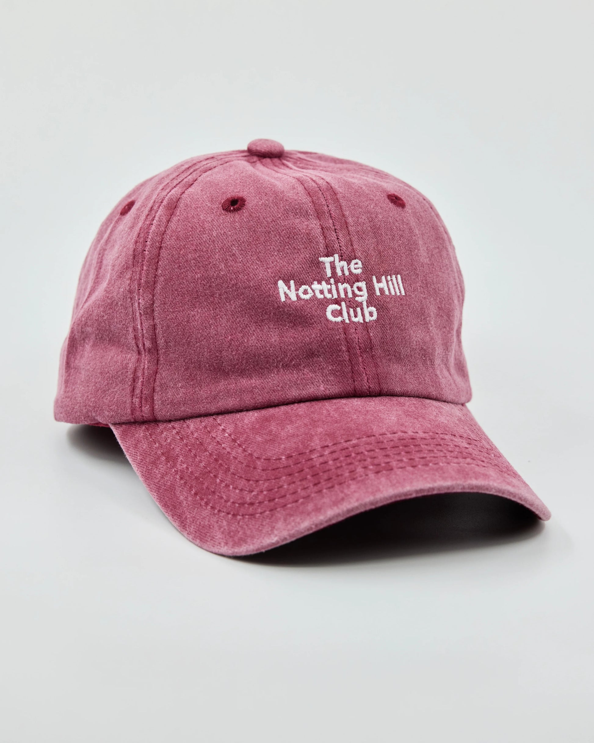 side view of The Notting Hill Club Burgundy Washed Cap