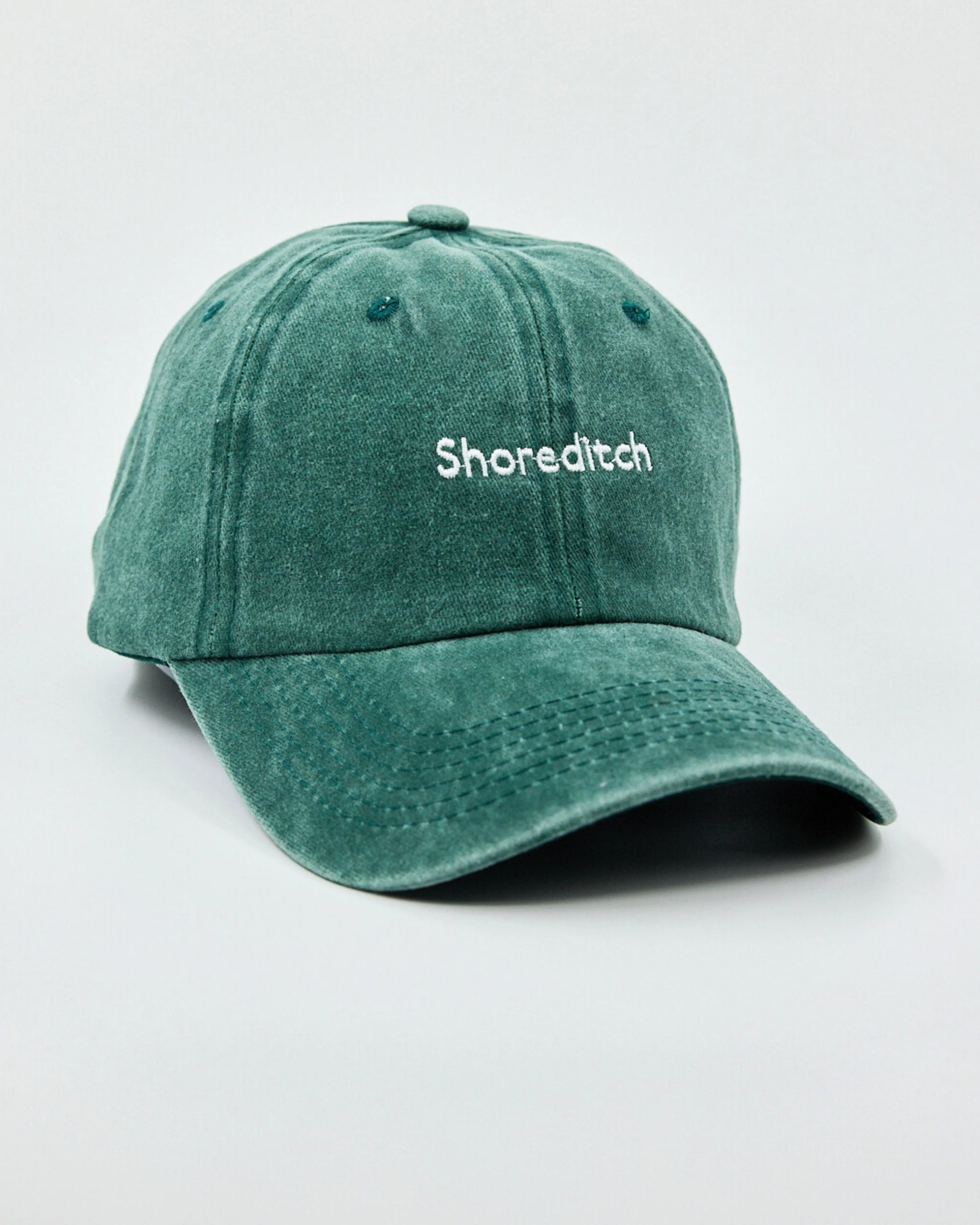 Side view of The Notting Hill Club Dark Green Washed Cap
