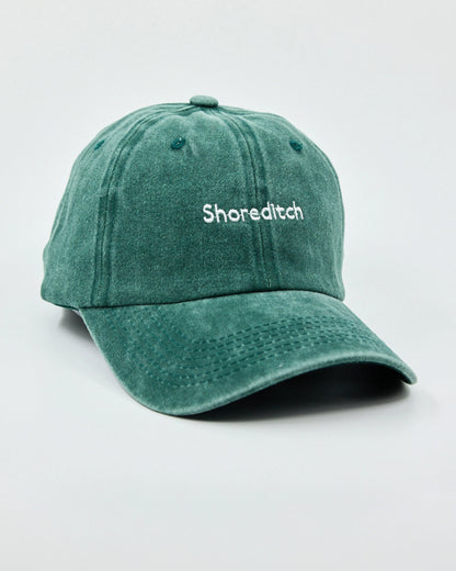 Side view of The Notting Hill Club Dark Green Washed Cap