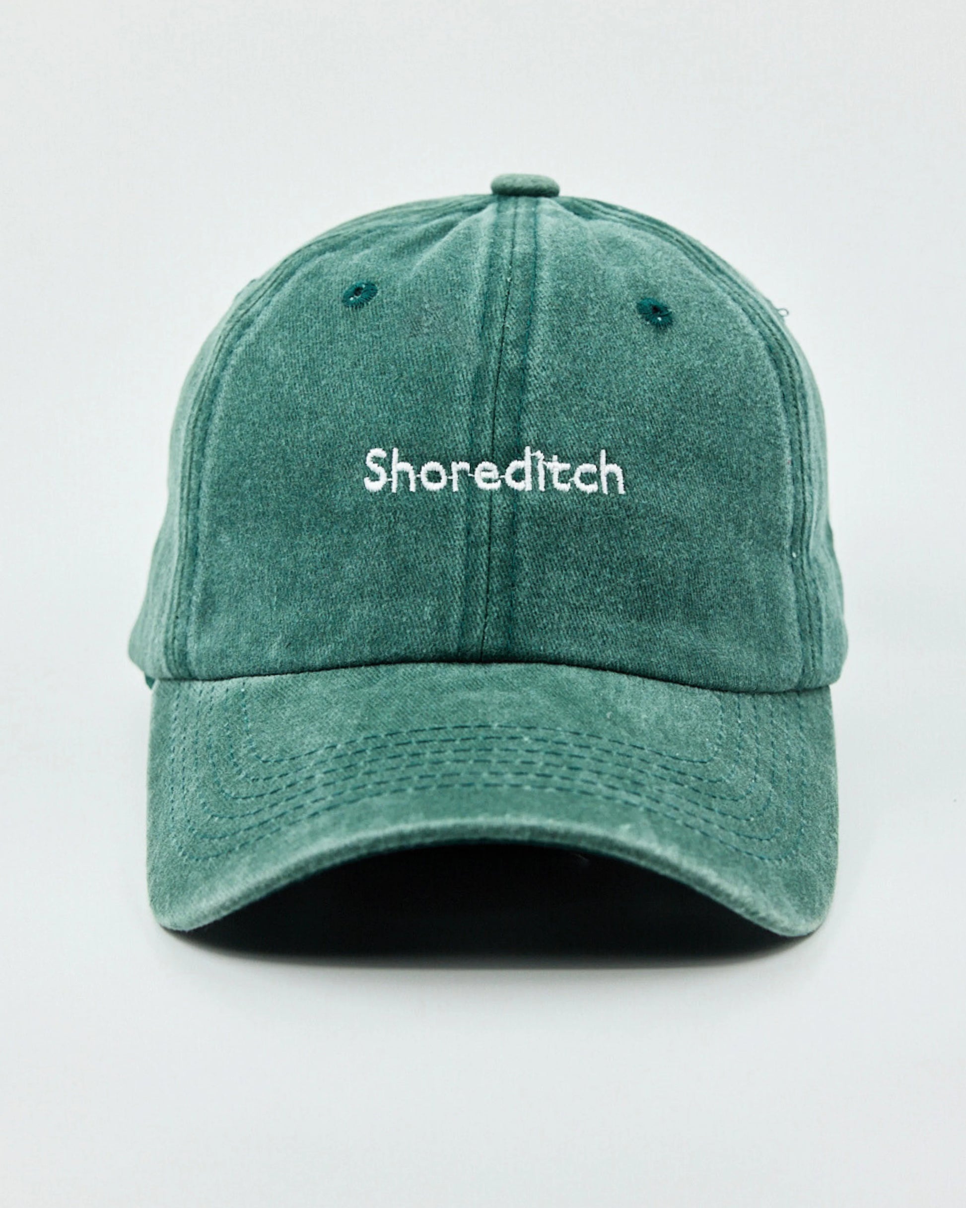 Front view of The Notting Hill Club Dark Green Washed Cap