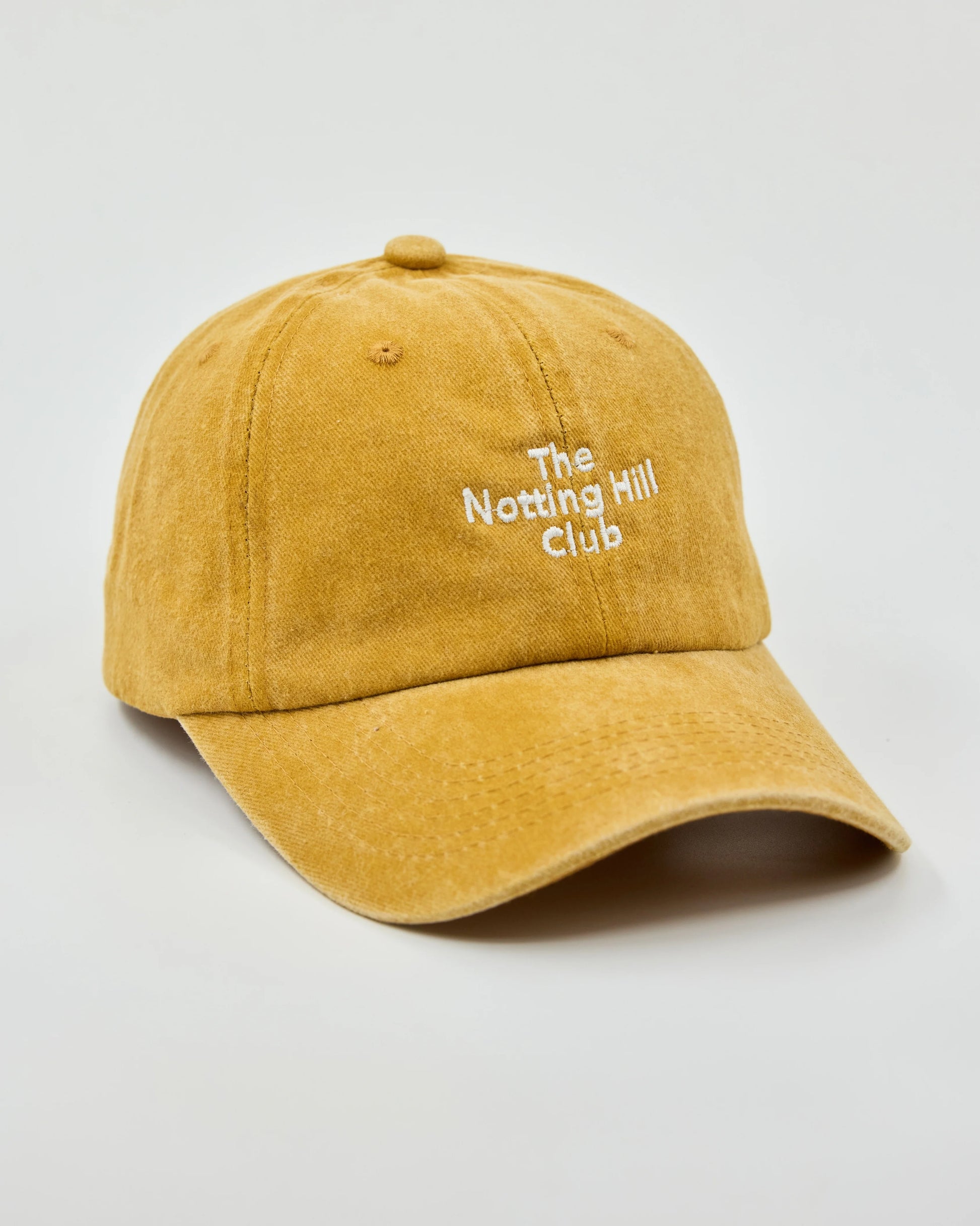Side view of The Notting Hill Club Mustard Washed Cap