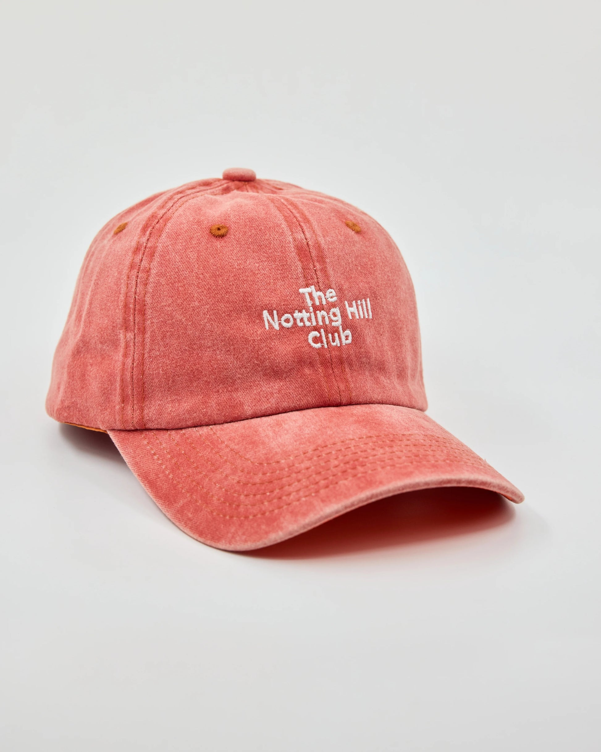 side view of The Notting Hill Club Orange Washed Cap