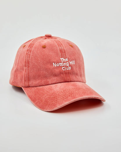 side view of The Notting Hill Club Orange Washed Cap
