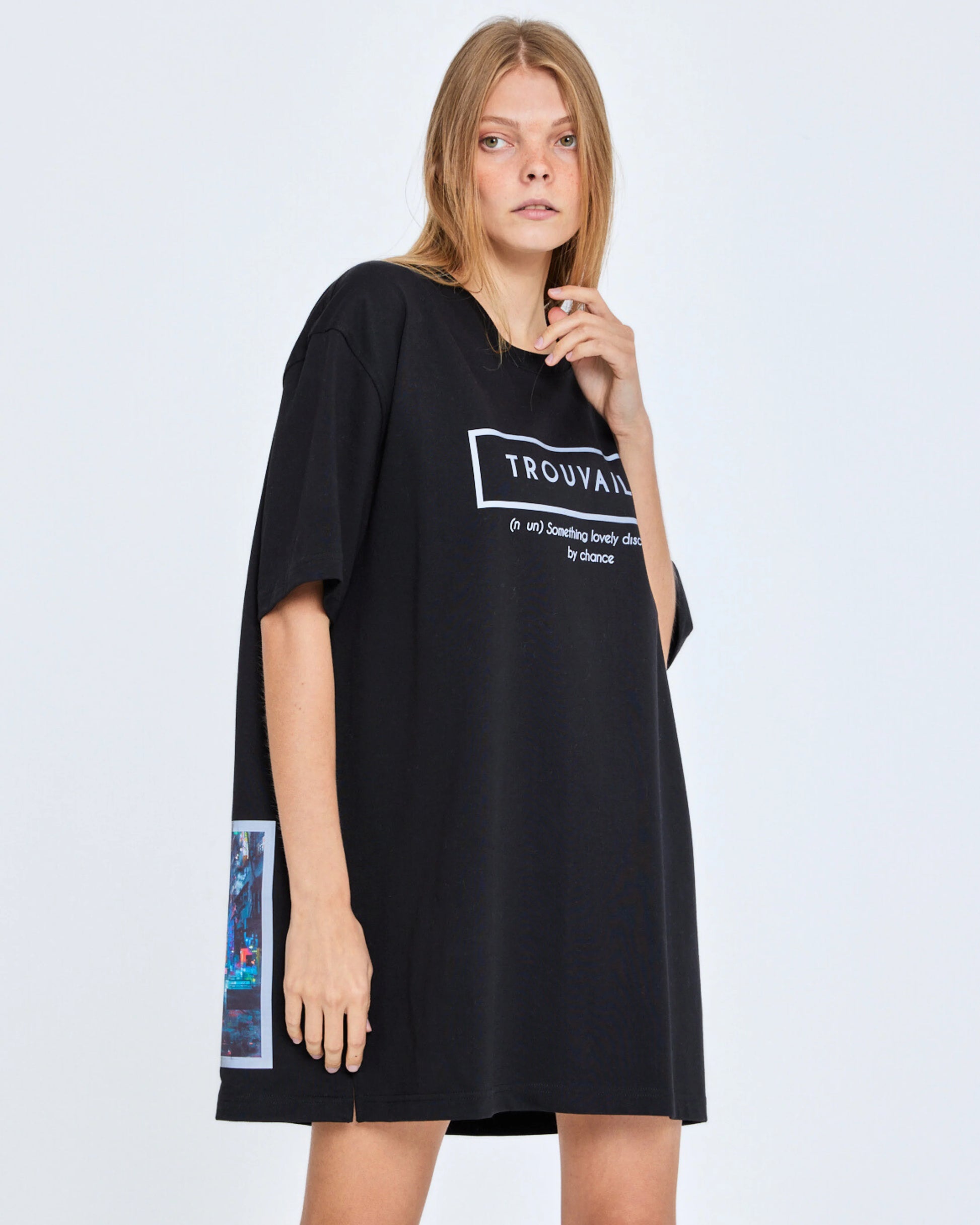 Woman wearing a black dress with a Truvaille text on a white background