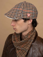 Person wearing Vegas Beige Casket Hat and scarf against a beige background