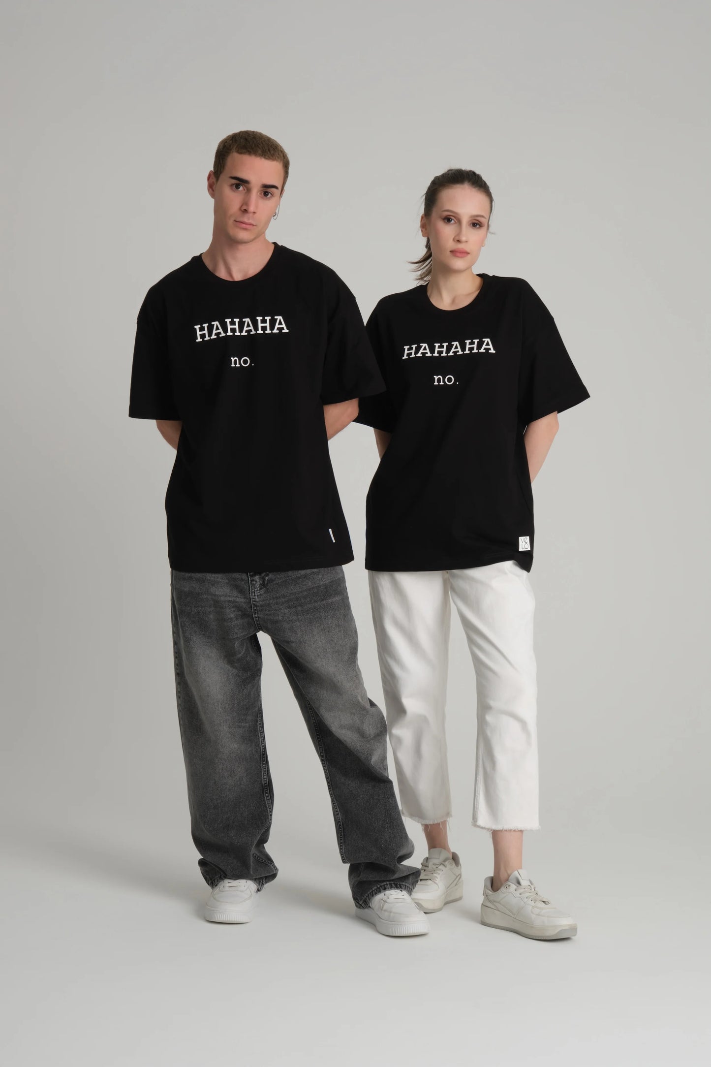 front view of male and female model wearing hahaha no black tee