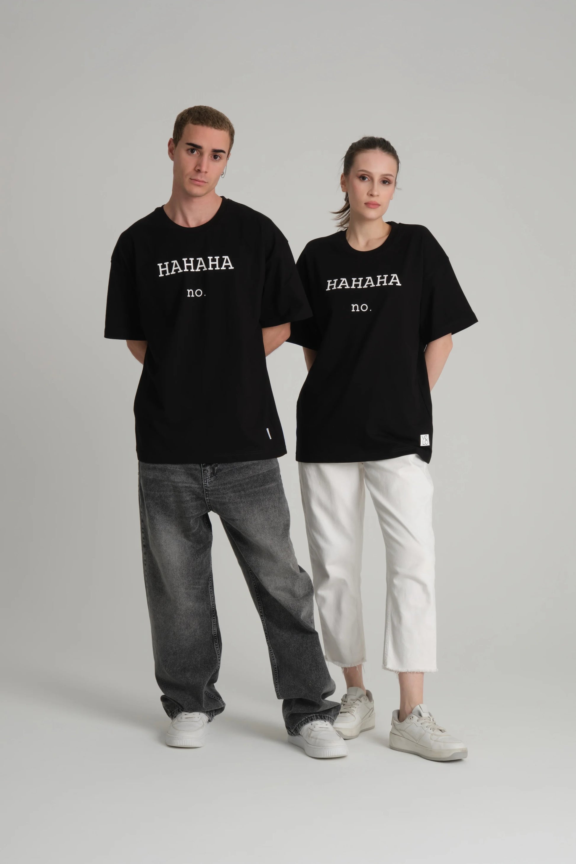 front view of male and female model wearing hahaha no black tee