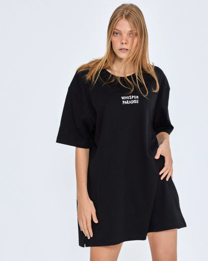 Woman wearing a black dress with 'Whisper Paradise' text on a white background