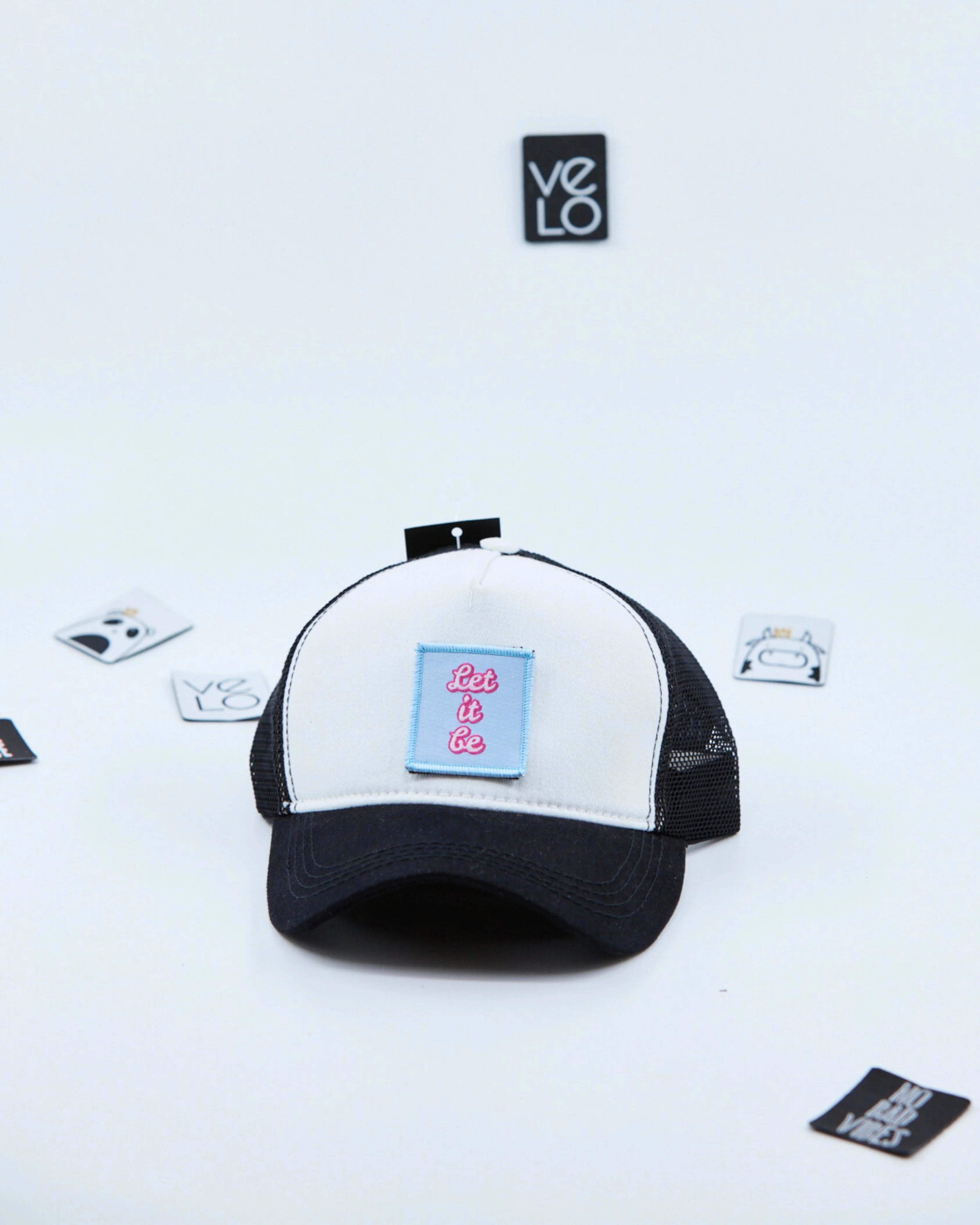 Side view of White and Black Customisable Trucker Cap with patches