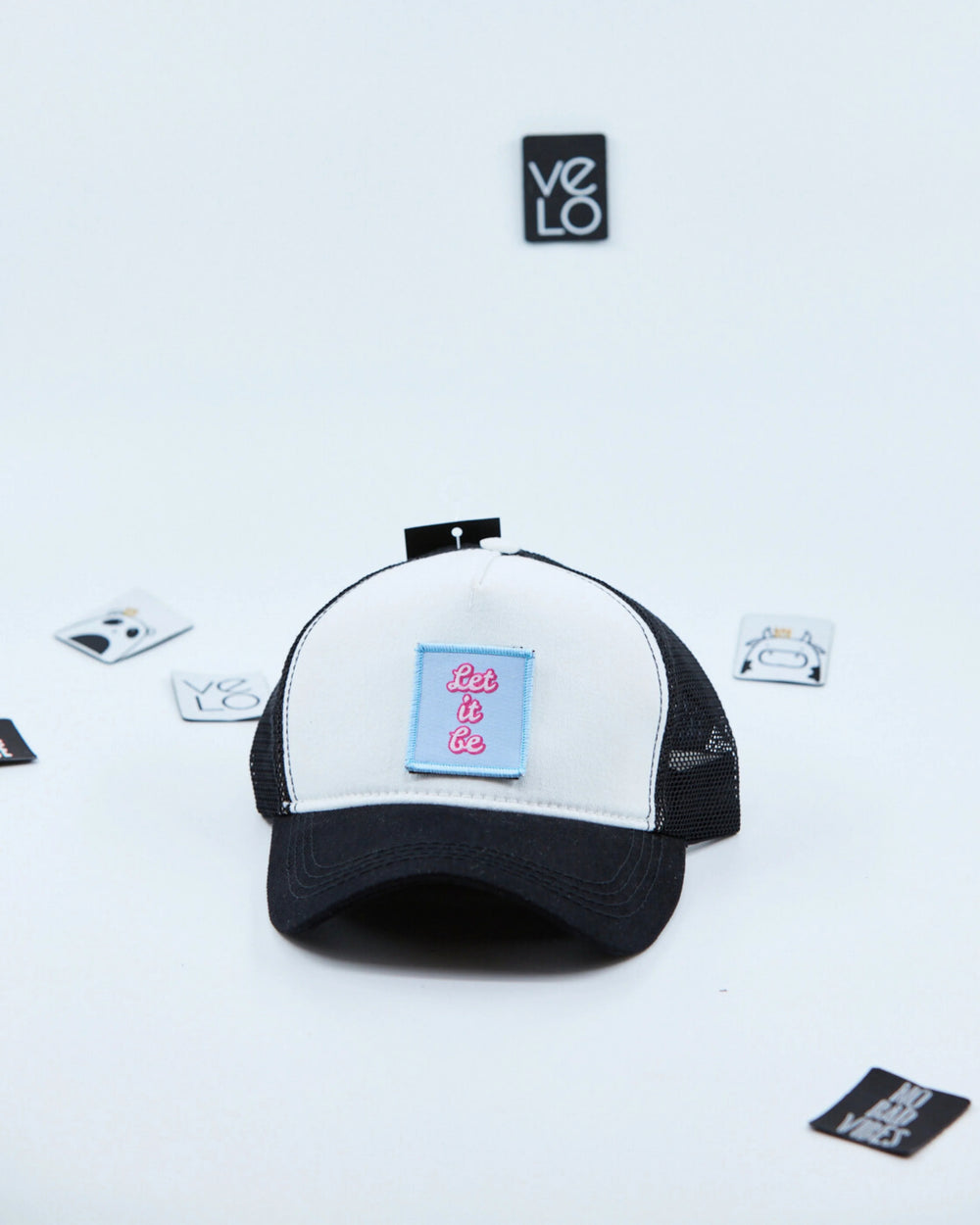 Side view of White and Black Customisable Trucker Cap with patches