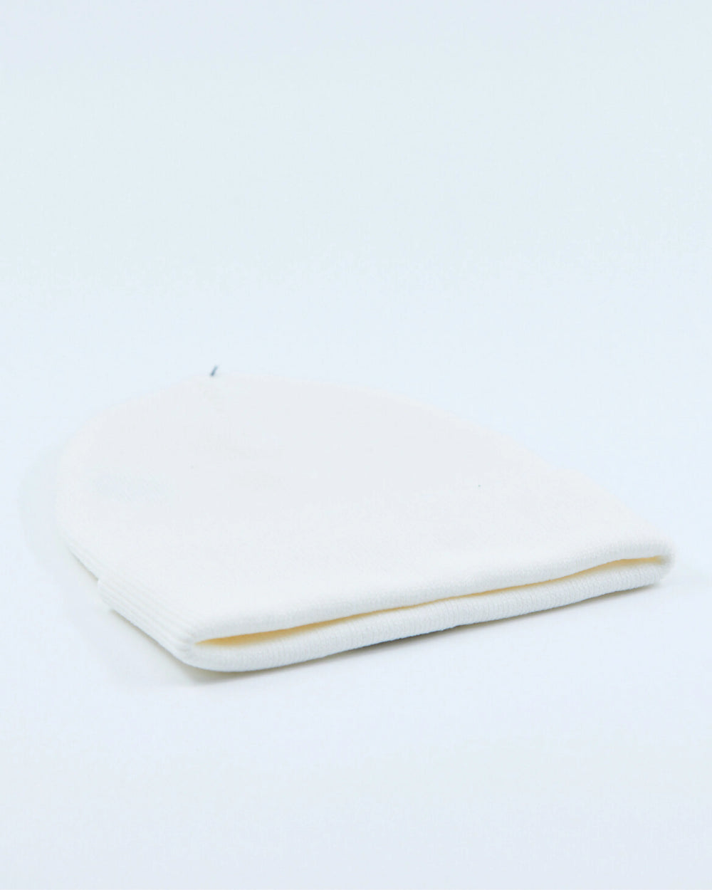White beanie on a light gray background