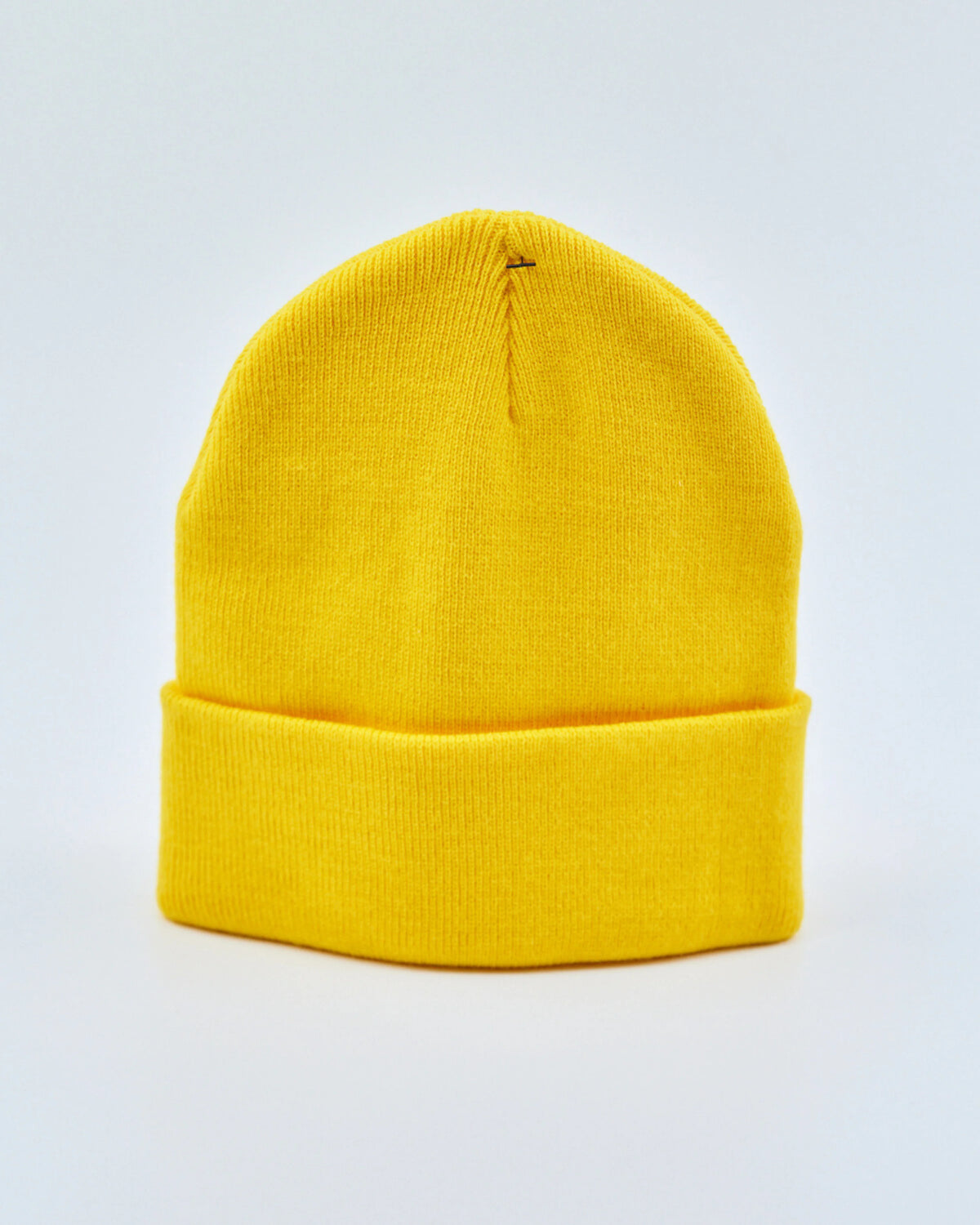Yellow beanie on a light gray background