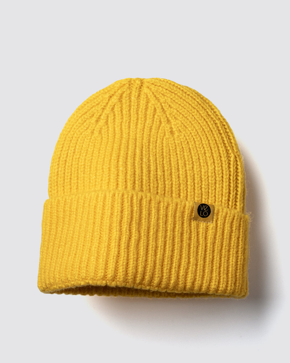 Yellow Lux Beanie on a light gray background