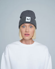 women model wearing dark grey patch ready beanie with 'N' letter patch on the front