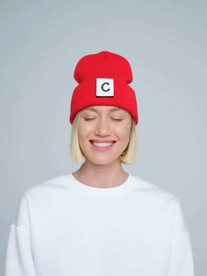 women wearing hot red beanie with 'C' letter patch on it