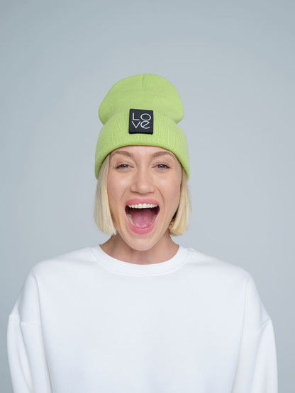 model wearing light green patch ready beanie with LOVE text patch on the front 