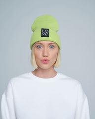 model wearing light green patch ready beanie with LOVE text patch on the front 