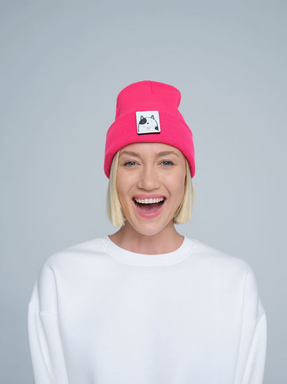 women wearing neon pink beanie with a cat design patch on the front
