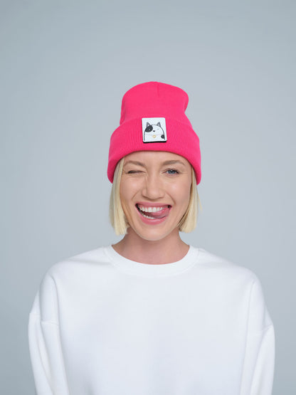 women wearing neon pink beanie with a cat design patch on the front