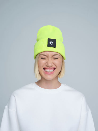 women wearing neon yellow beanie with a 'e' letter patch on it 