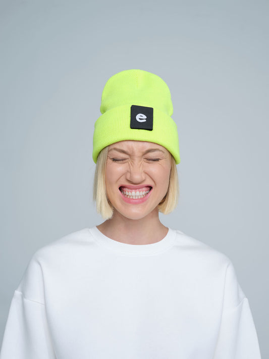 women wearing neon yellow beanie with a 'e' letter patch on it 