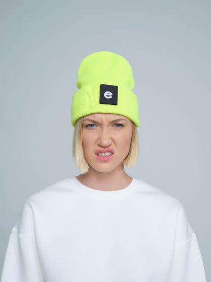 women wearing neon yellow beanie with a 'e' letter patch on it 