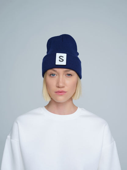 women wearing royal navy beanie with 'S'  letter patch on it