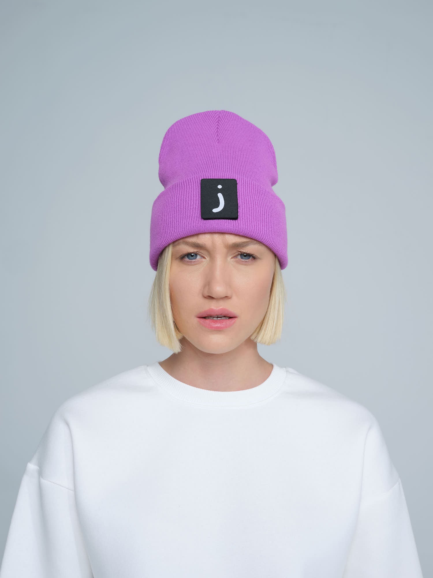 female person wearing purple patch ready beanie