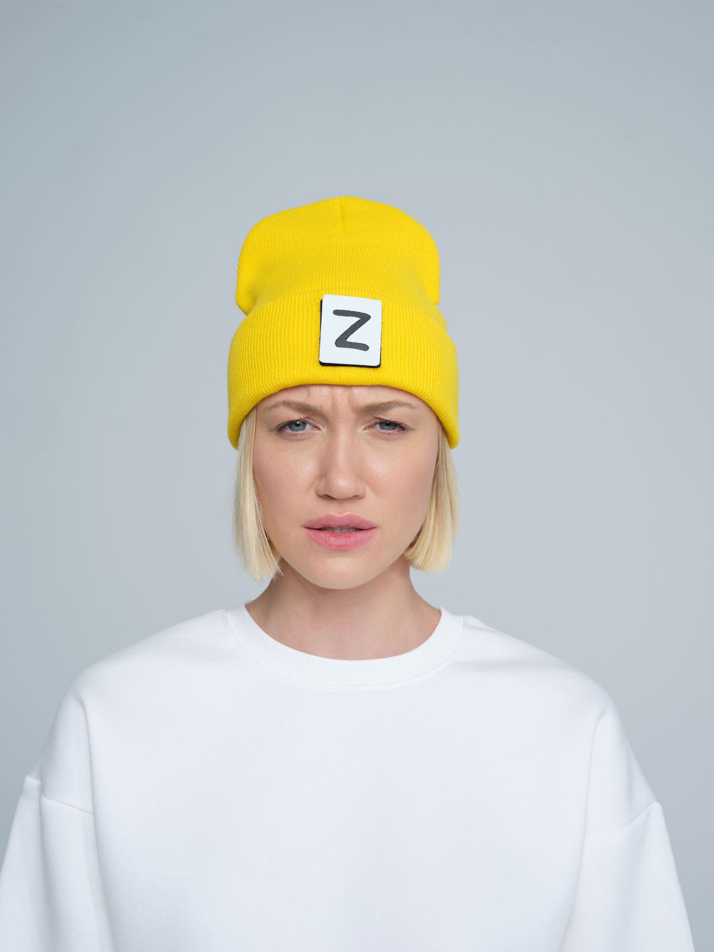 front look of women wearing yellow beanie with Z letter patch