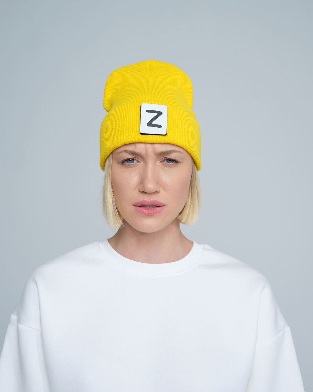 front look of women wearing yellow beanie with Z letter patch